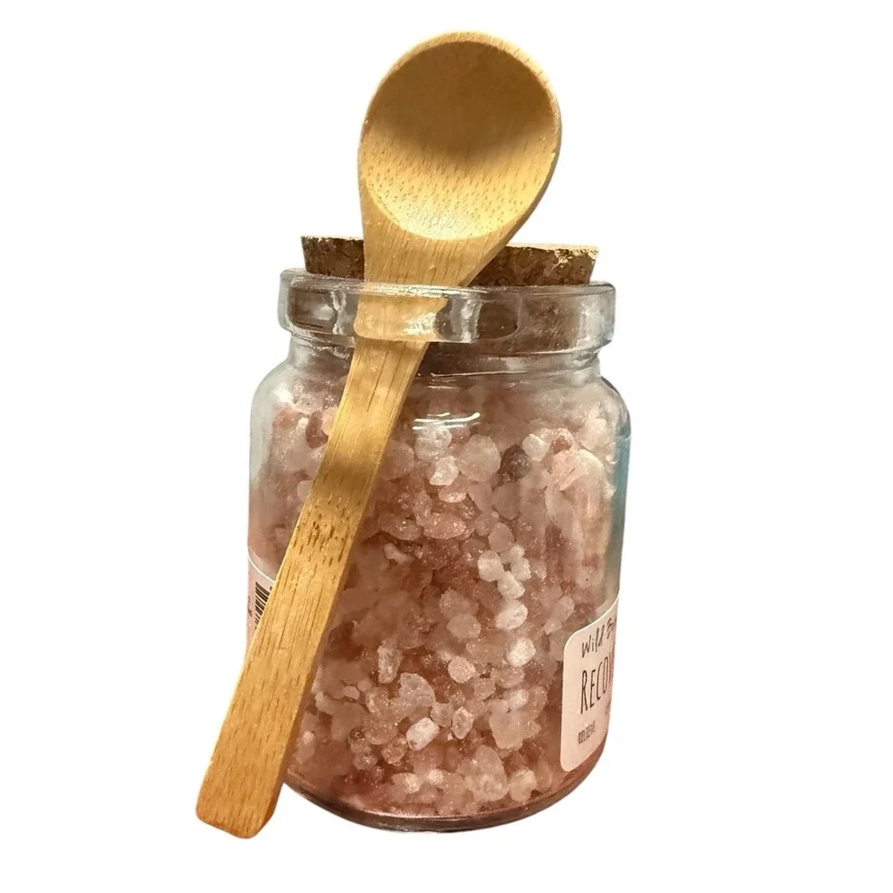 Wild Botanicals Recovery Bath Salts 10 oz glass jar with wooden spoon
